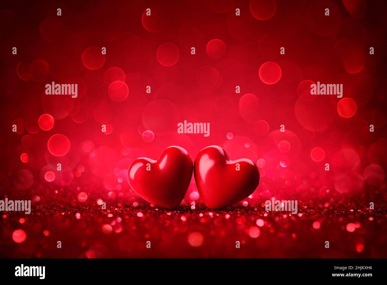 Valentines Red Hearts On Shiny Glitter Background With Defocused Abstract Lights Stock Photo