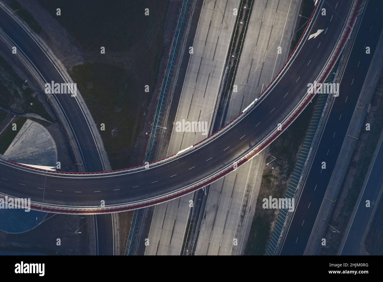 Top down perspective of curved road, road flyover aerial view ...
