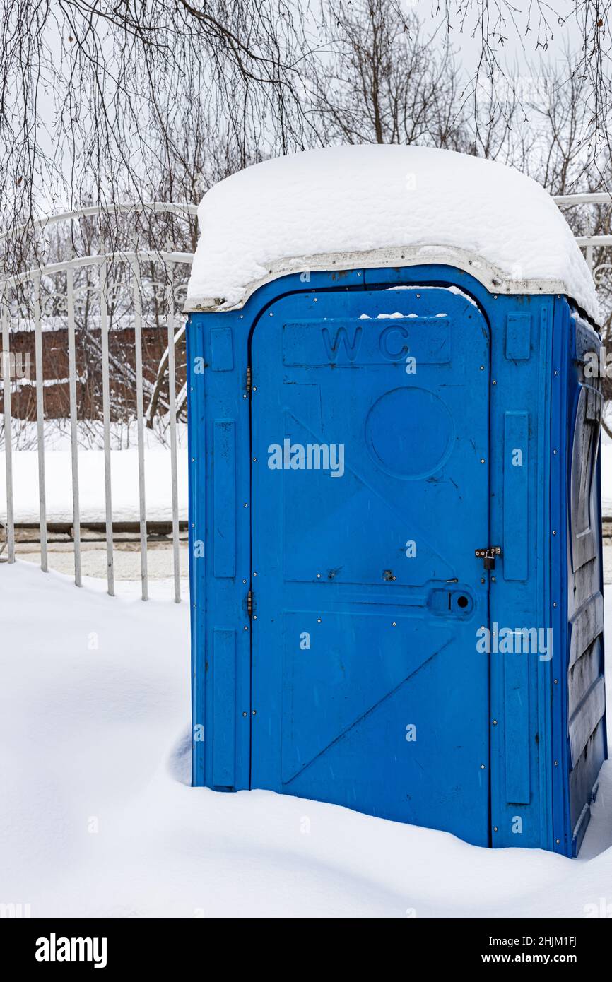 outdoor toilet cabin covered in snow in winter. High quality photo Stock Photo