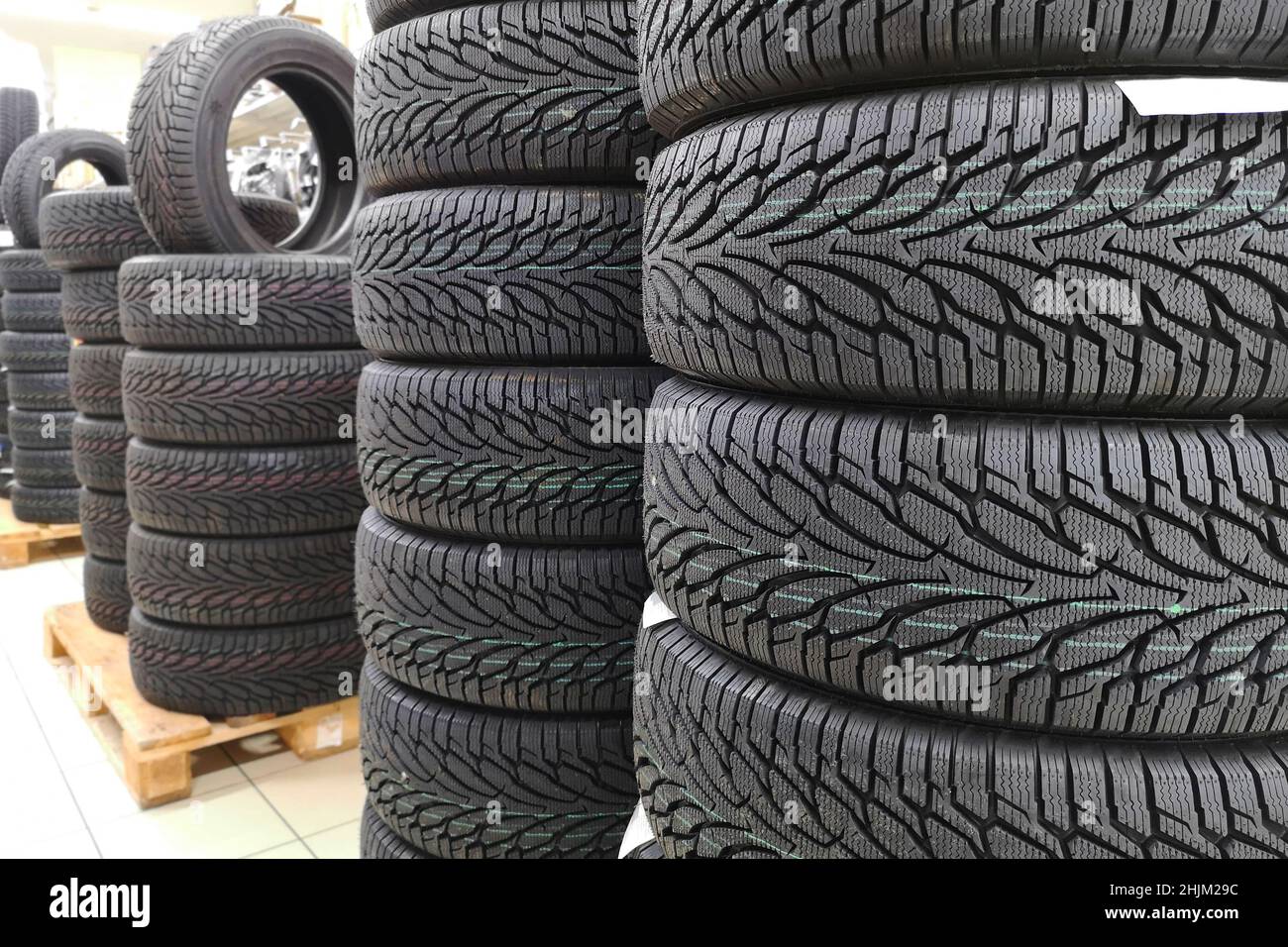 Car tires in auto store. Tires for sale in a tire store stacks of new