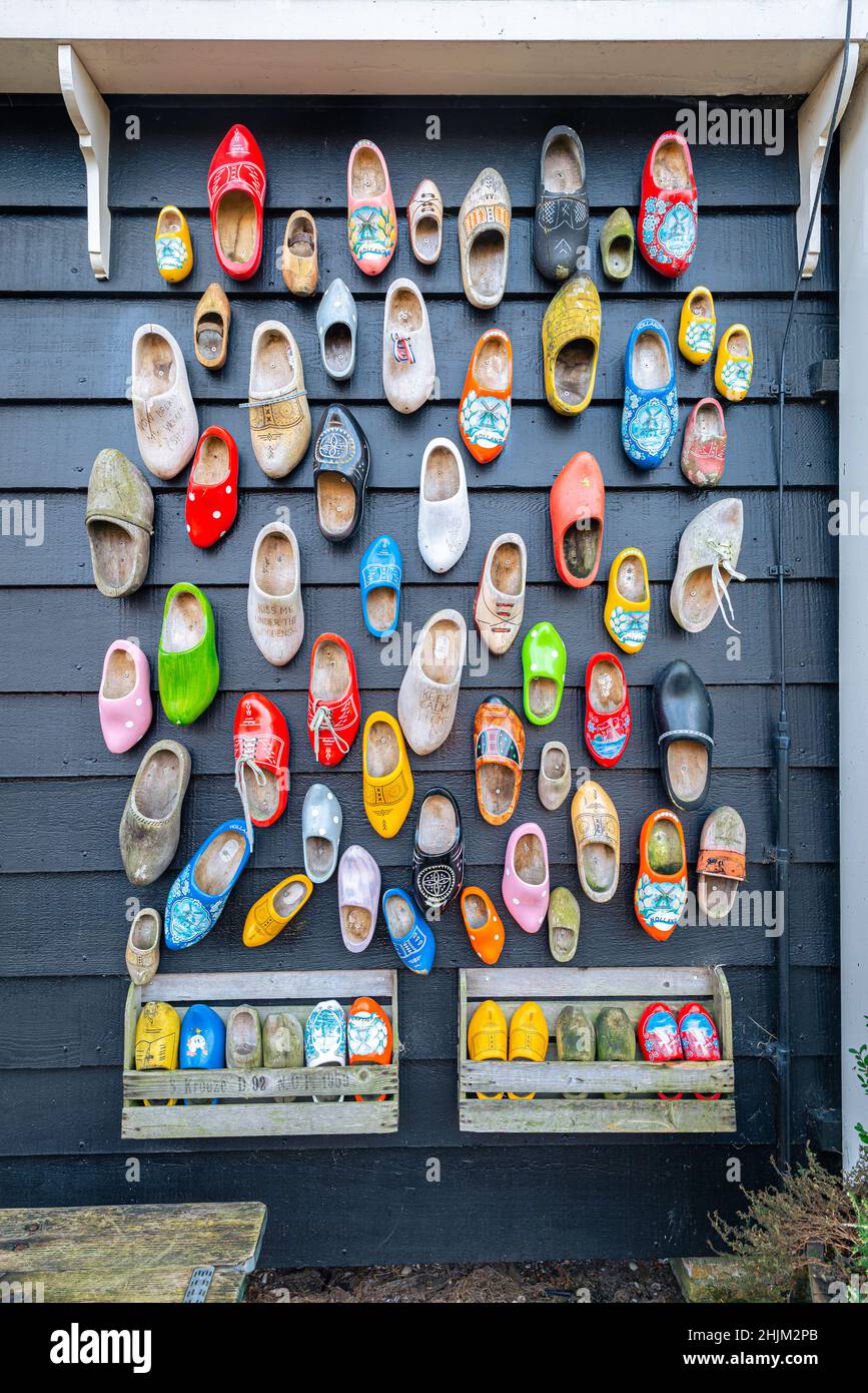 Decoratively painted Dutch clogs on the wall of a wooden barn Stock Photo