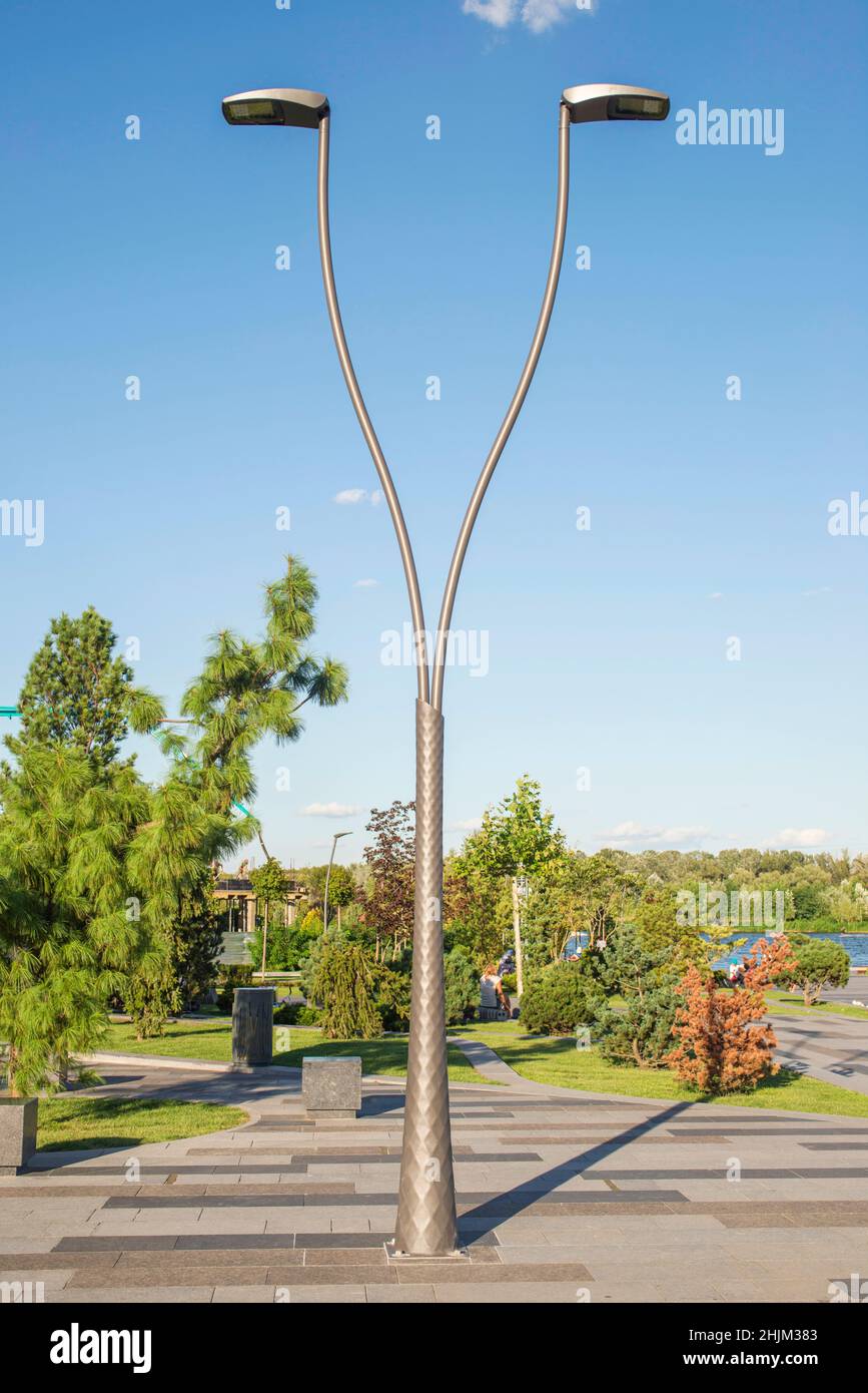 A modern street LED lighting pole at park. Urban electro-energy  technologies. Savings on street urban road lighting Stock Photo - Alamy
