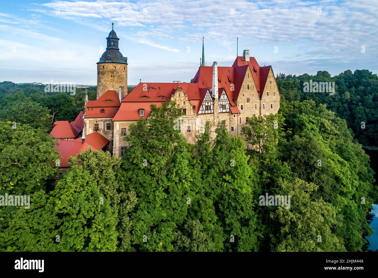 Czocha medieval castle in Lower Silesia in Poland. Built in 13th century (the main keep) with many later additions. Aerial view in summer, early morni Stock Photo