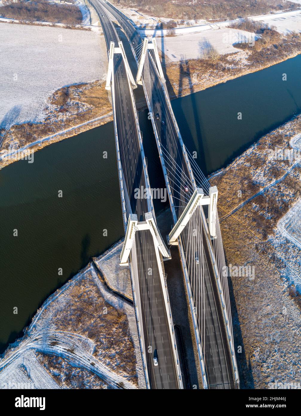 New modern Macharski double cable-stayed three-lane suspension bridge over Vistula River in Krakow, Poland. Aerial view from above in winter. Part of Stock Photo