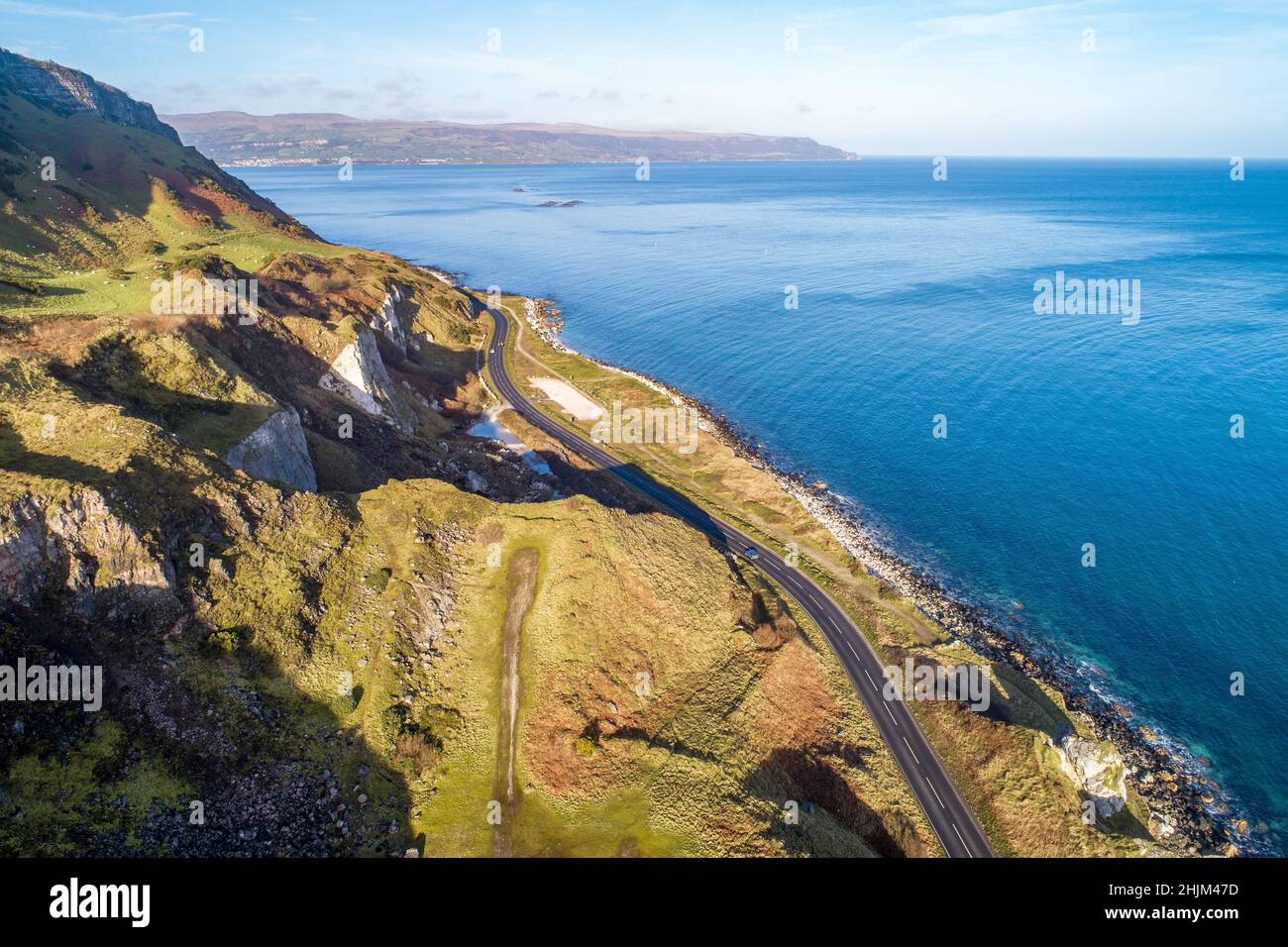 The eastern coast of Northern Ireland and Causeway Coastal Route a.k.a Antrim Coast Road A2. One of the most scenic coastal roads in Europe. Aerial vi Stock Photo