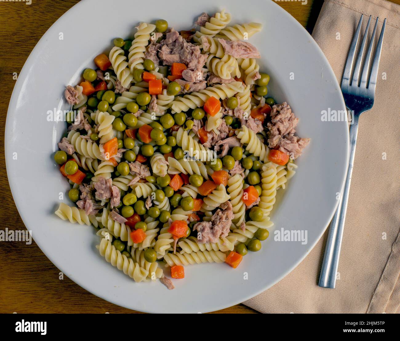 rotini pasta salad with carrots and peas top with tuna Stock Photo Alamy