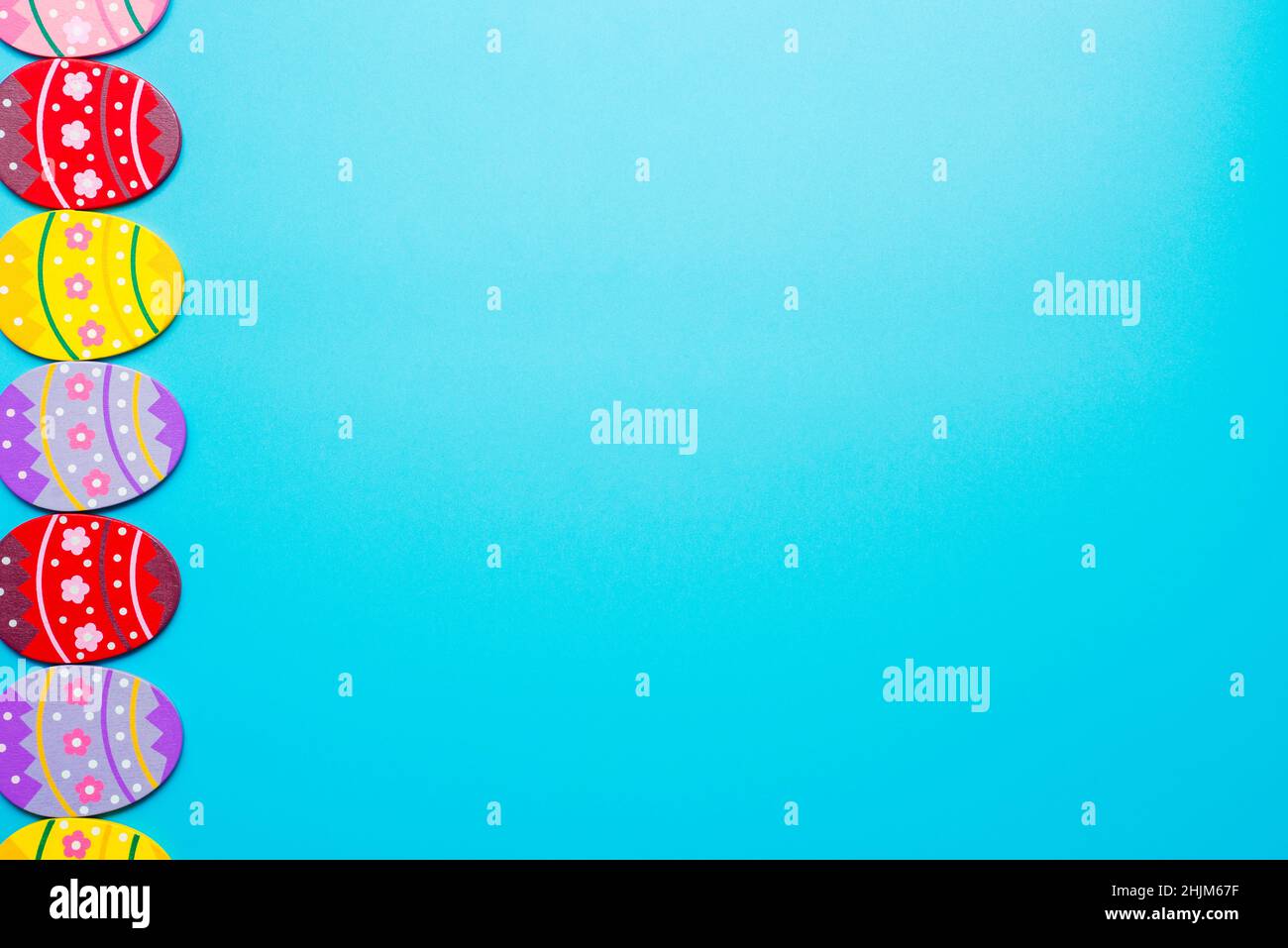 Easter Eggs. Colorful Easter eggs on blue background with copy space. Stock Photo