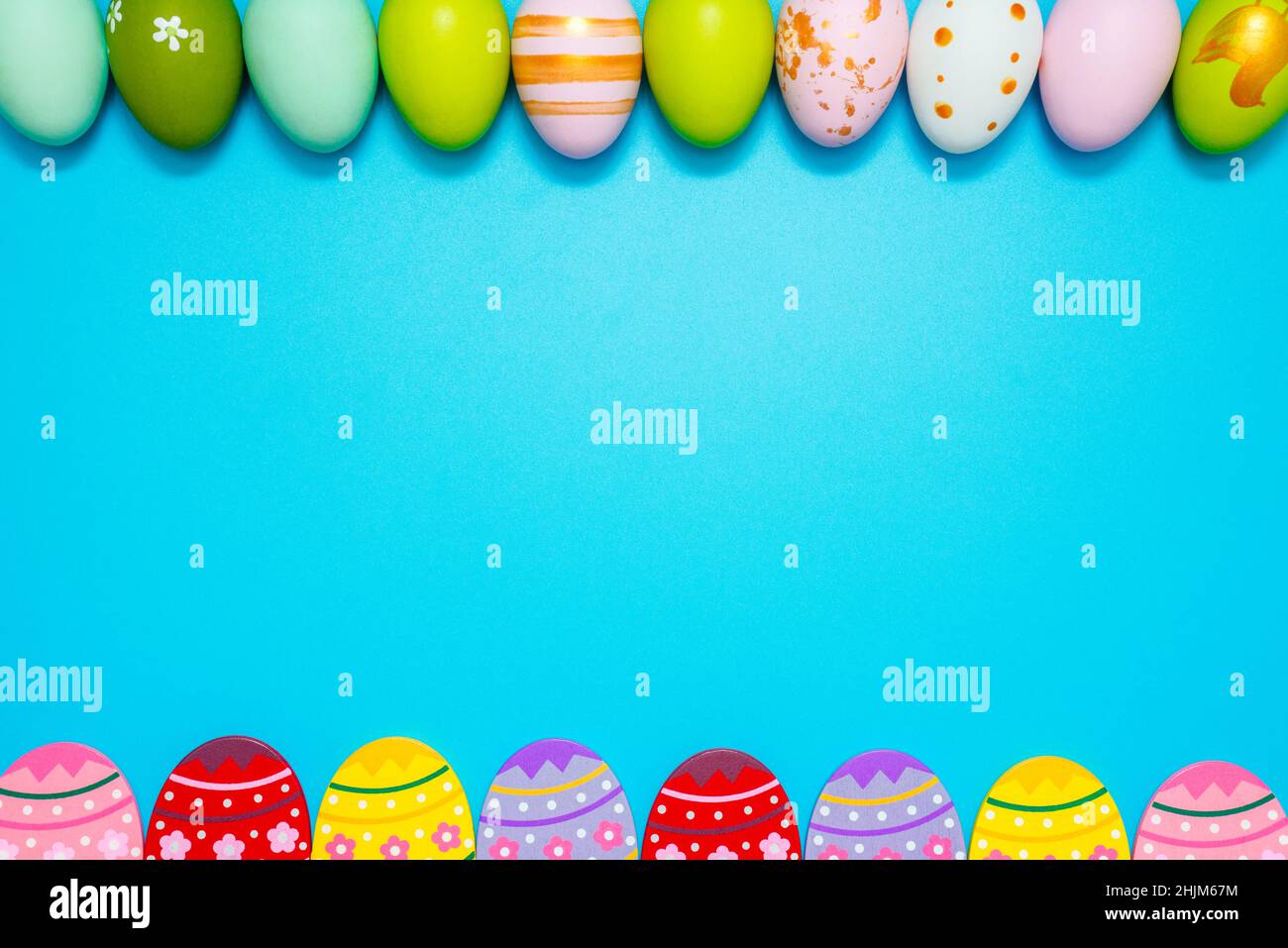 Easter Eggs. Colorful Easter eggs on blue background with copy space. Stock Photo
