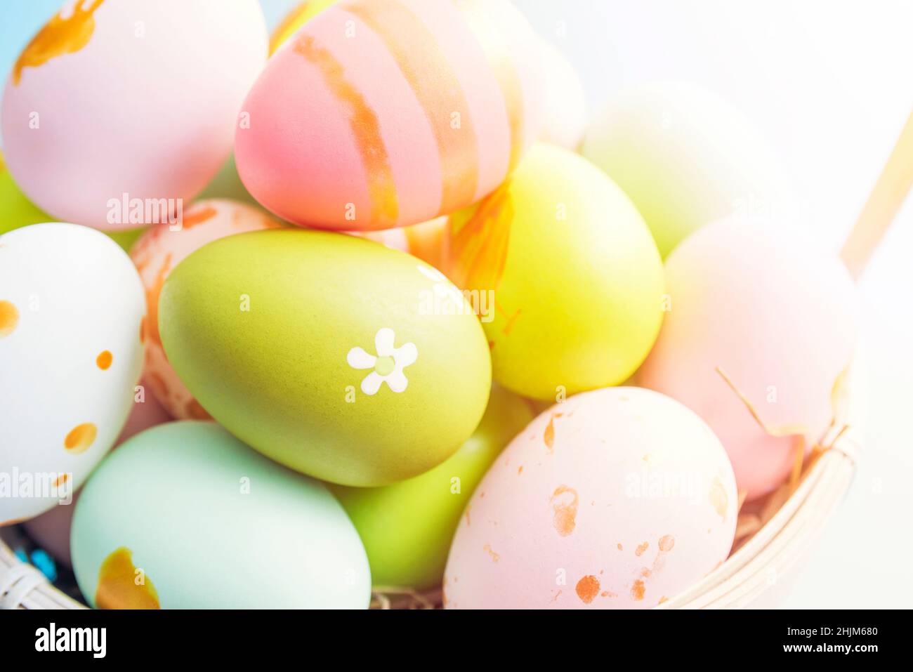 Easter basket filled with painted Easter eggs. Colorful painted Easter eggs in basket. Stock Photo