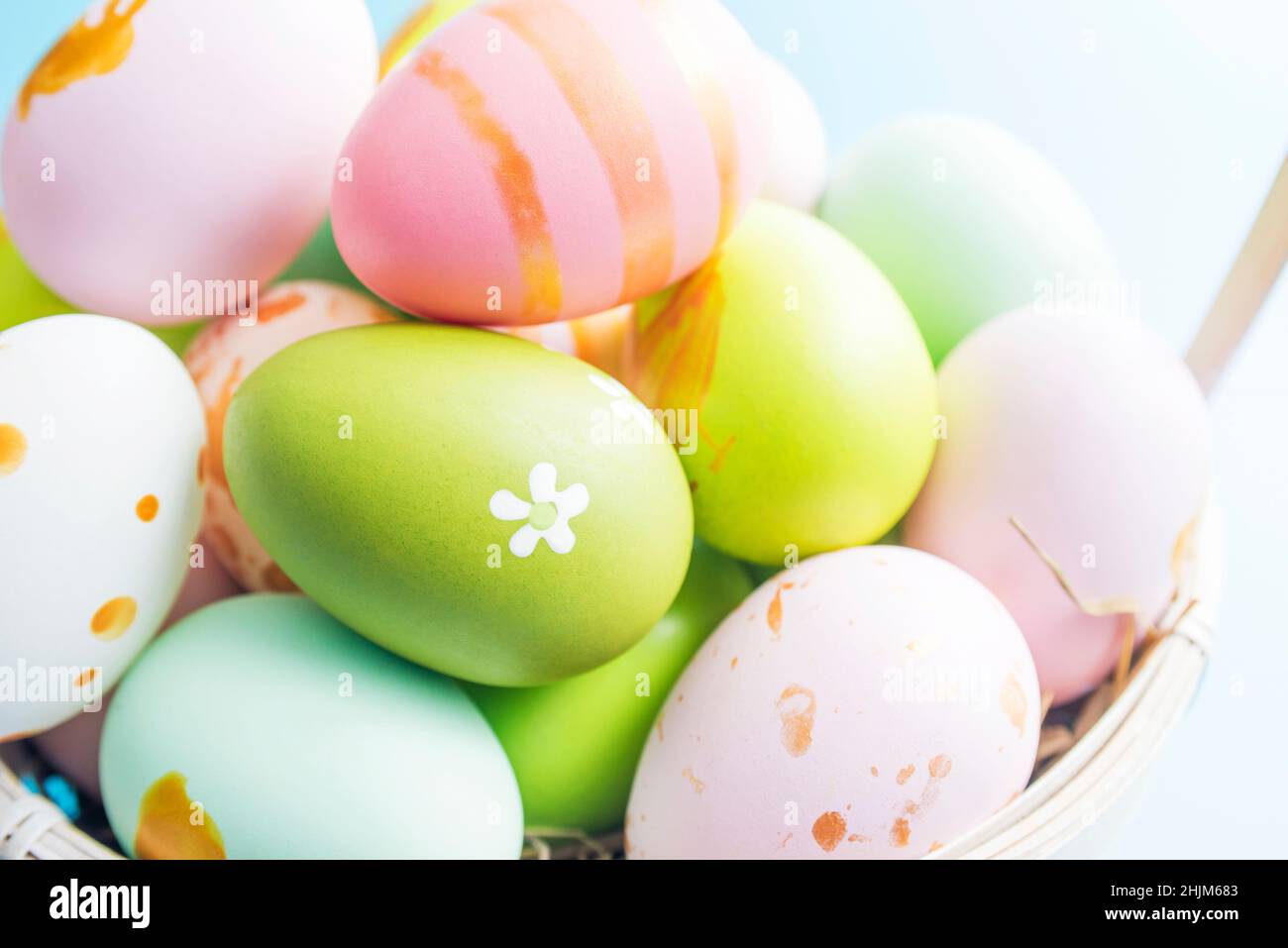 Easter basket filled with painted Easter eggs. Colorful painted Easter eggs in basket. Stock Photo
