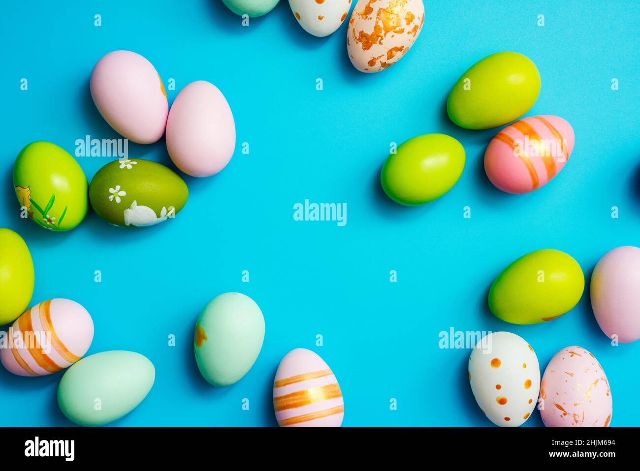 Easter Eggs. Colorful Easter eggs on blue background with copy space. Stock Photo