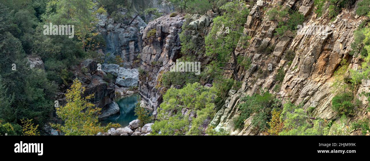 wooded mountain canyon with a clear blue river in a rocky bed Stock ...