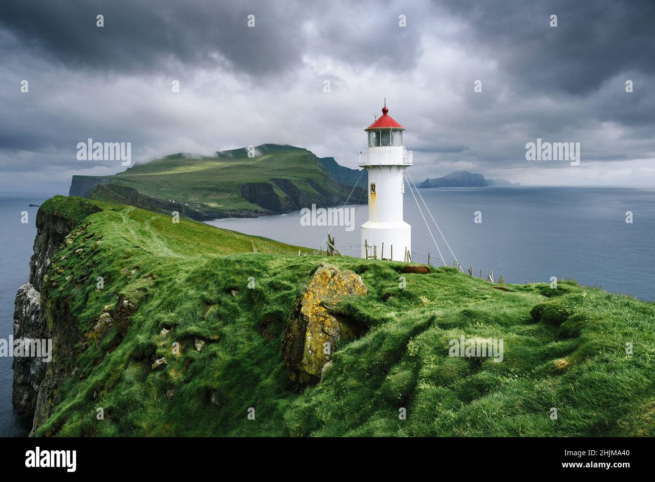 landscape with Mykines Holmur Lighthouse on Faroe Islands, Denmark Stock Photo