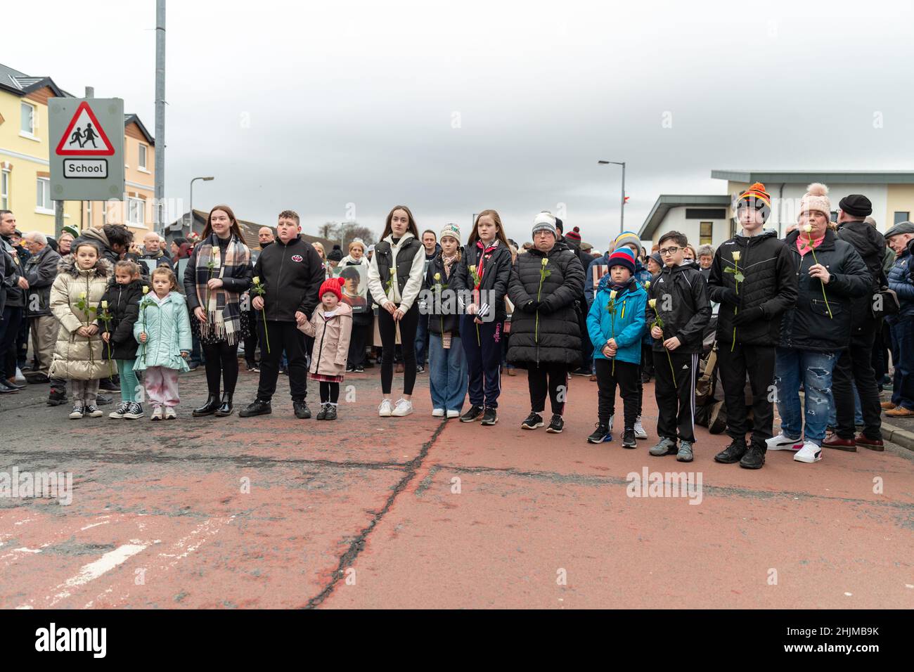 Derry, UK. 30th Jan, 2022. Central Drive, Derry, Family members of those who lost loved ones on Bloody Sunday(30th January 1972) gathered to walk the route in an act of remembrance. At the Bloddy Sunday Memorial, Wreaths were laid by Family and Politicians from the North and South of Ireland. Credit: Bonzo/Alamy Live News Stock Photo