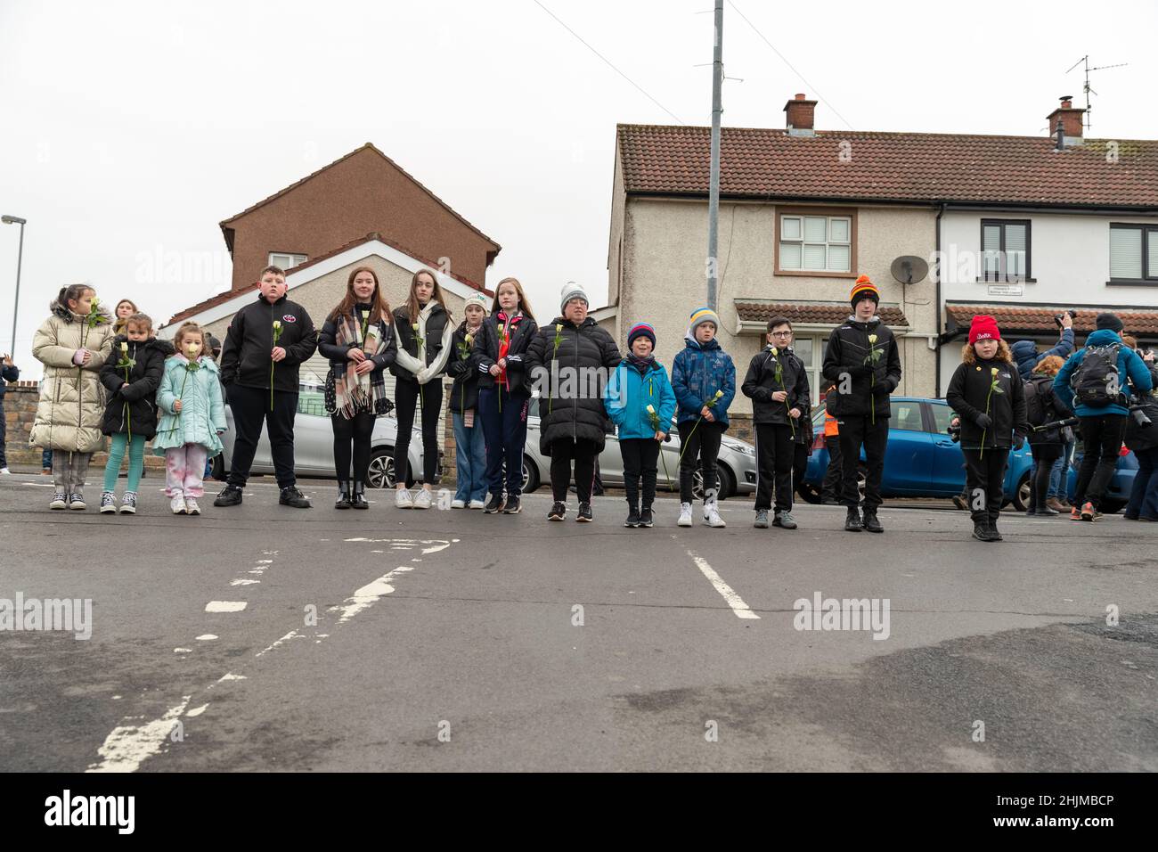 Derry, UK. 30th Jan, 2022. Central Drive, Derry, Family members of those who lost loved ones on Bloody Sunday(30th January 1972) gathered to walk the route in an act of remembrance. At the Bloddy Sunday Memorial, Wreaths were laid by Family and Politicians from the North and South of Ireland. Credit: Bonzo/Alamy Live News Stock Photo