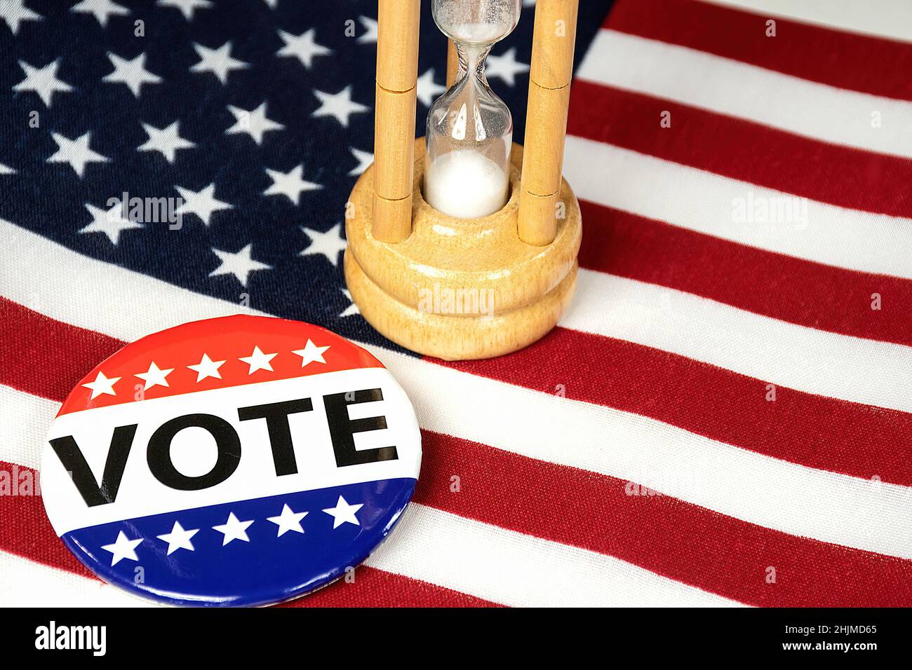 Close up of political  campaign button on American flag with a sand timer Stock Photo