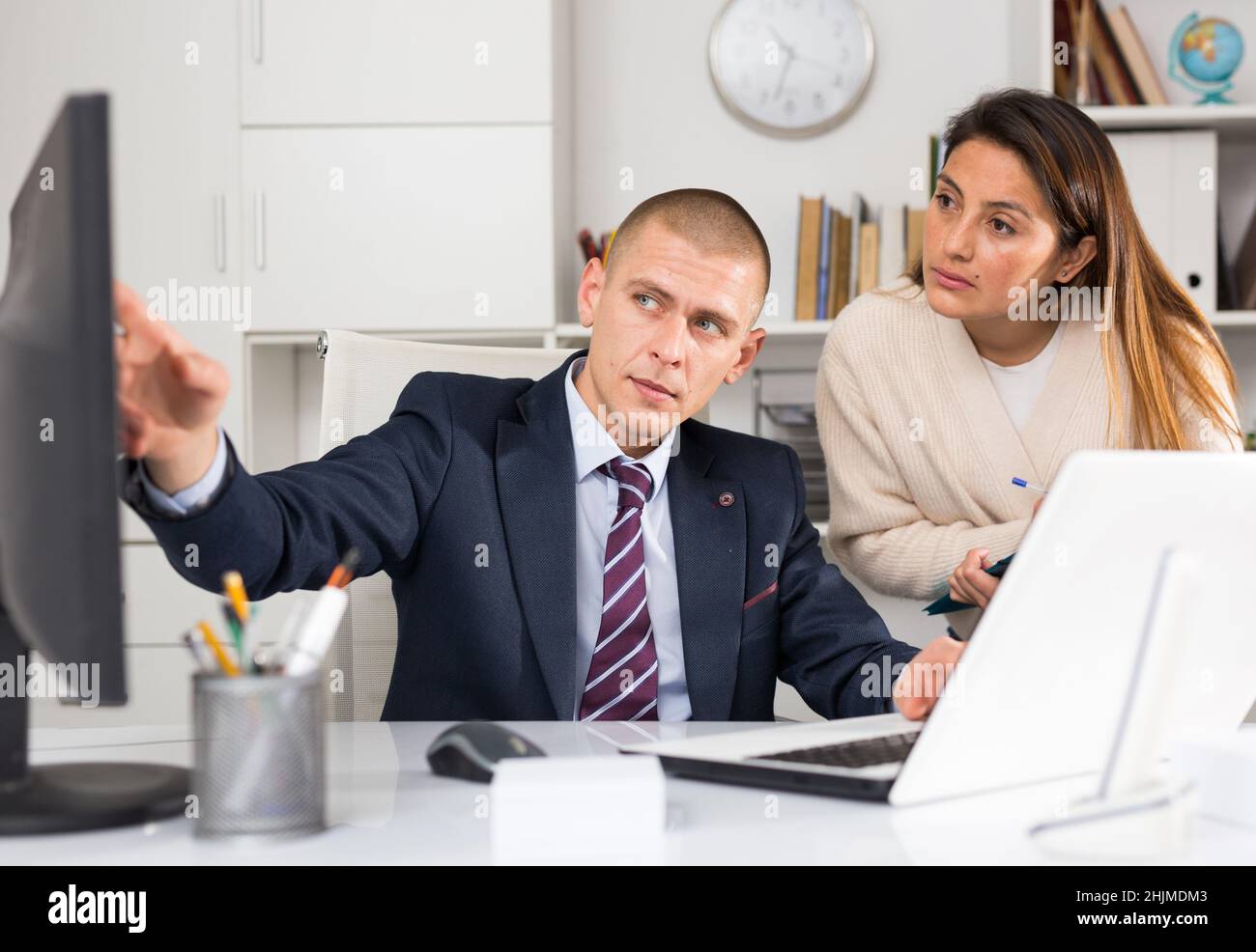 Successful businessman talking to female colleague Stock Photo