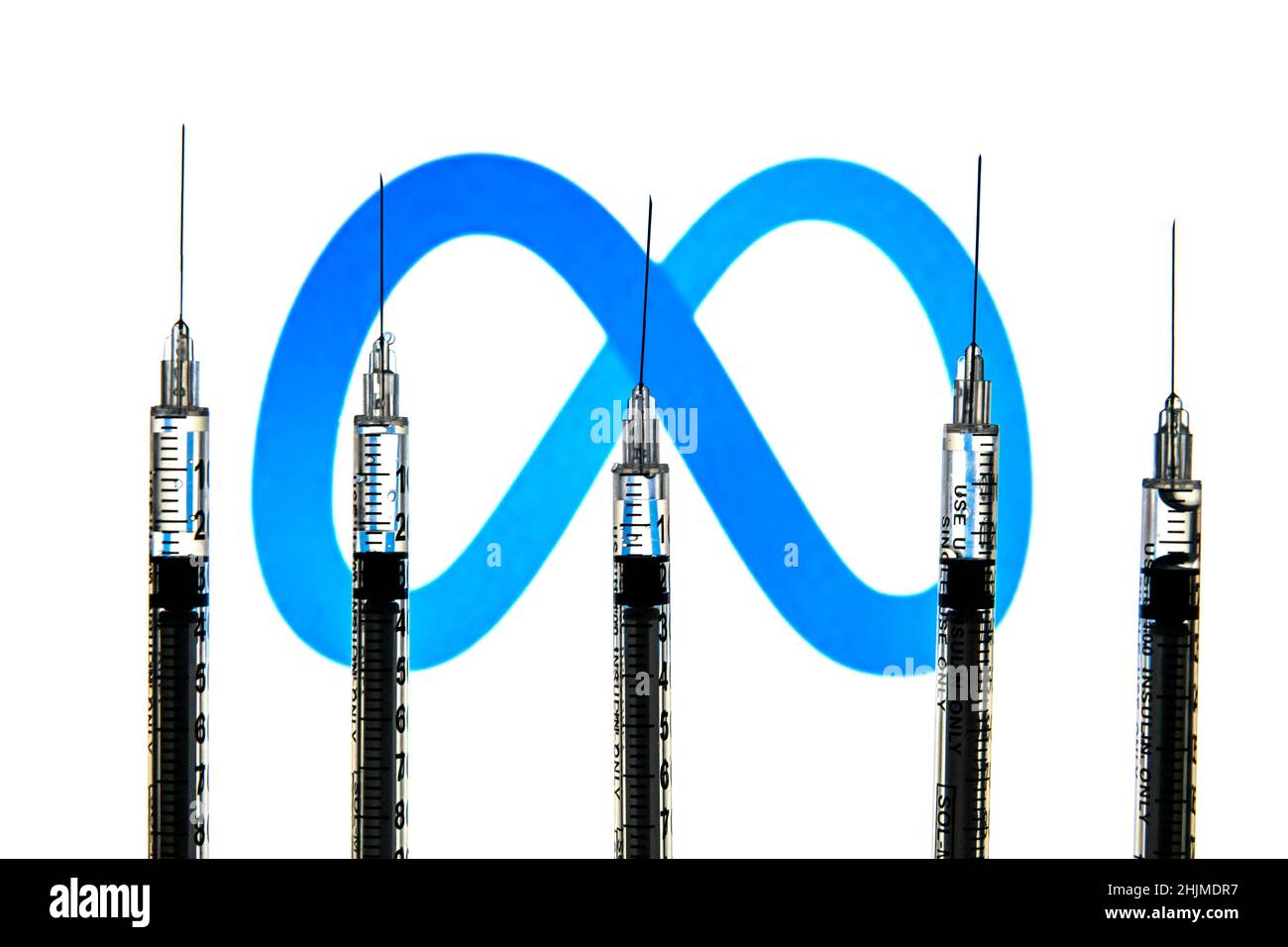 Spain. 24th Jan, 2022. In this photo illustration medical syringes seen with a Meta logo in the background. (Credit Image: © Thiago Prudencio/SOPA Images via ZUMA Press Wire) Stock Photo