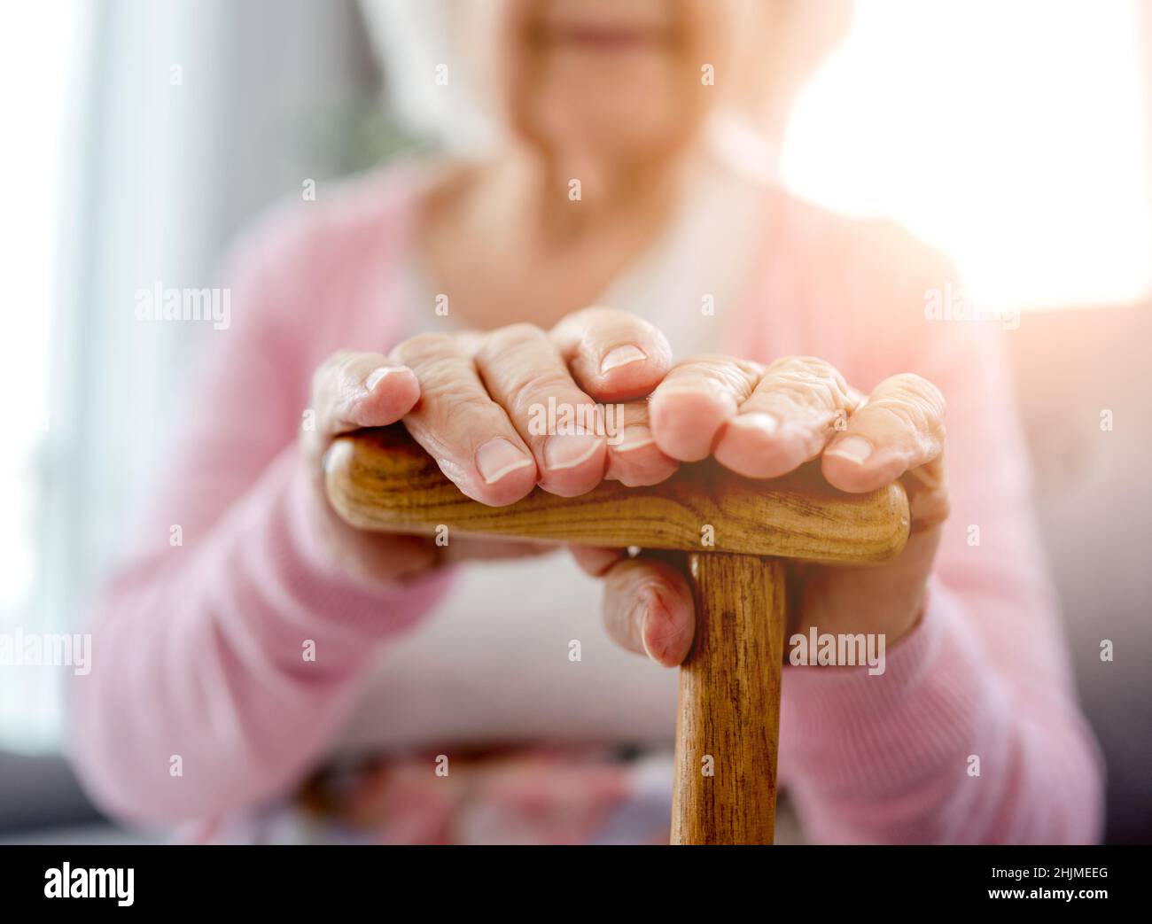 Senior woman with walking stick Stock Photo - Alamy