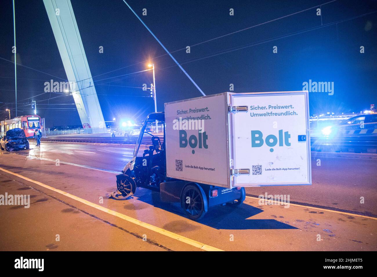 Cologne, Germany. 30th Jan, 2022. A cargo bike and a badly damaged car (l) are seen after an accident on the Severinsbrücke bridge in Cologne. (to dpa '22-year-old cargo bike rider hit by car - seriously injured') Credit: Vincent Kempf/dpa/Alamy Live News Stock Photo