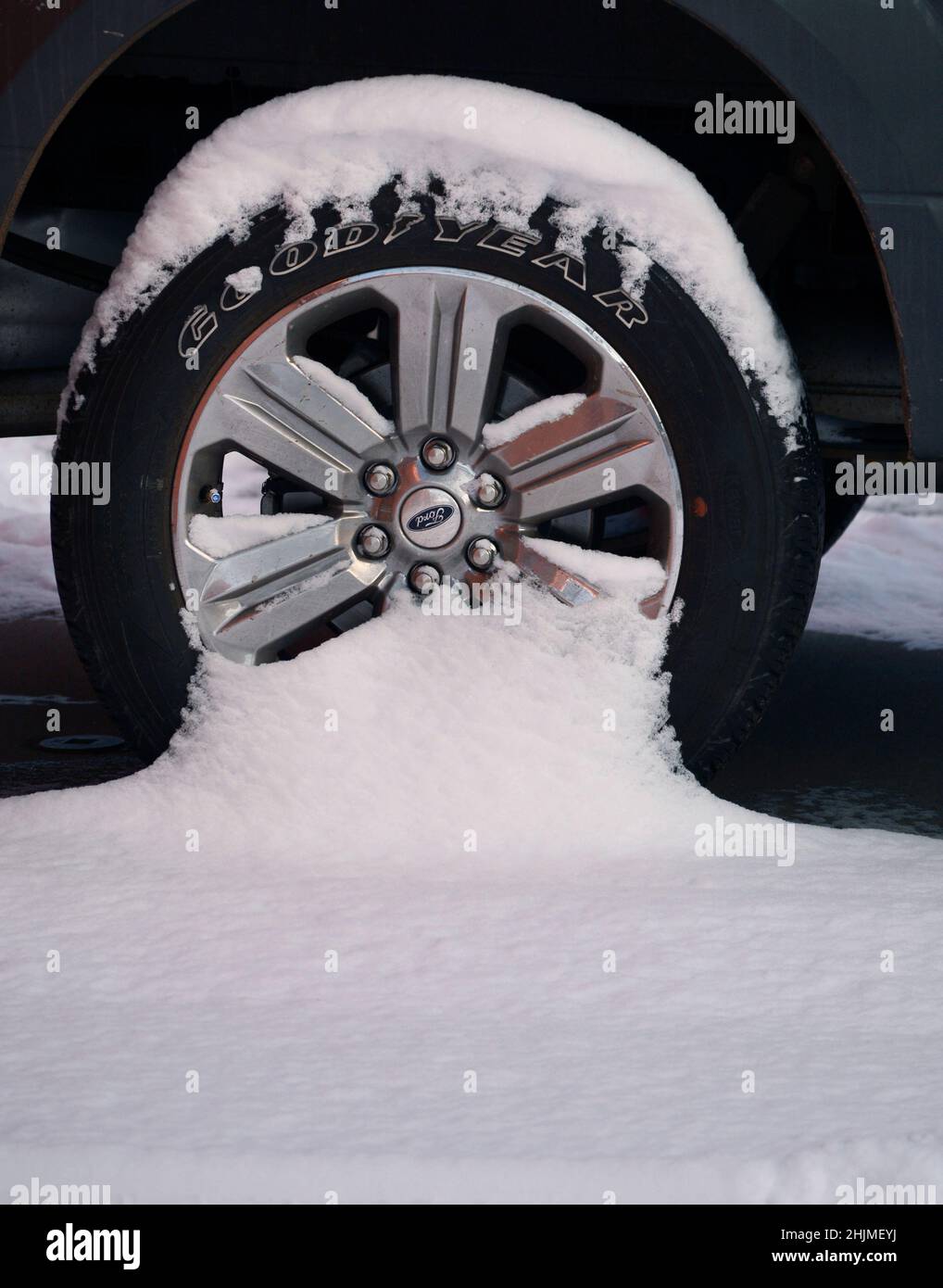 A Ford truck with Goodyear tires covered in snow in Santa Fe, New Mexico. Stock Photo