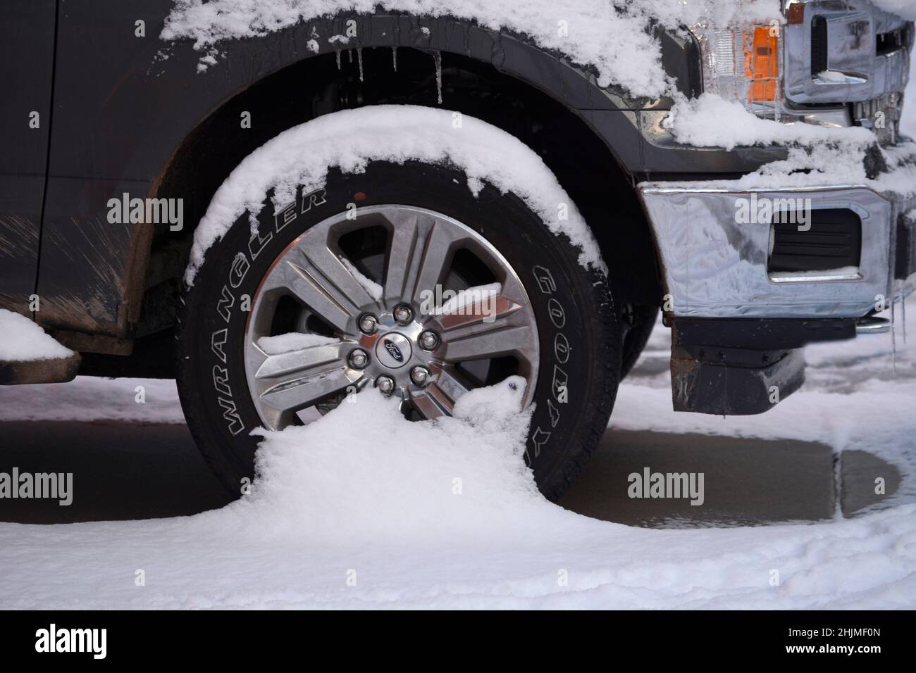 A Ford truck with Goodyear tires covered in snow in Santa Fe, New Mexico. Stock Photo