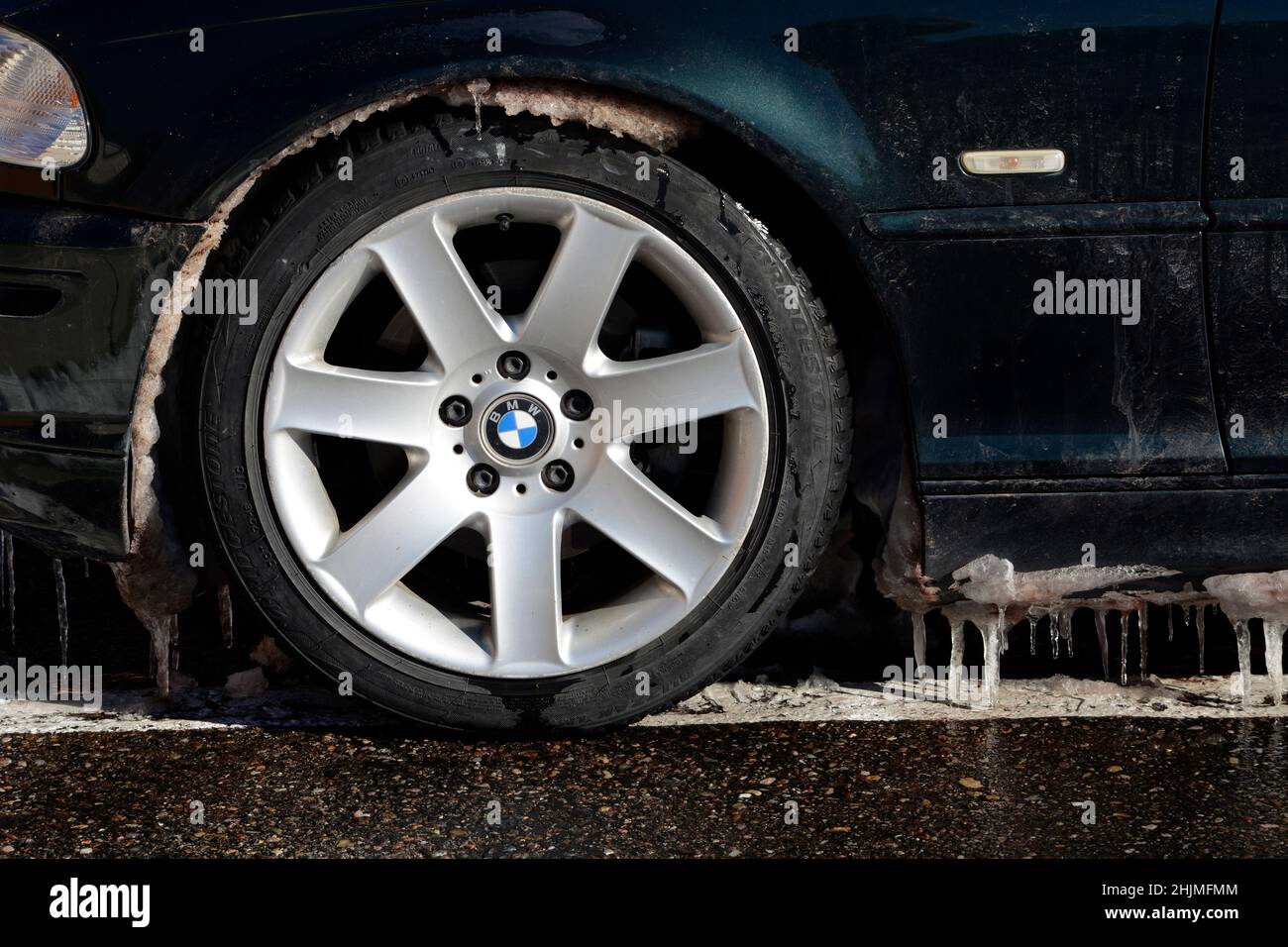 Icicles hang from the bottom of a BMW automobile parked in Santa Fe, New Mexico. Stock Photo