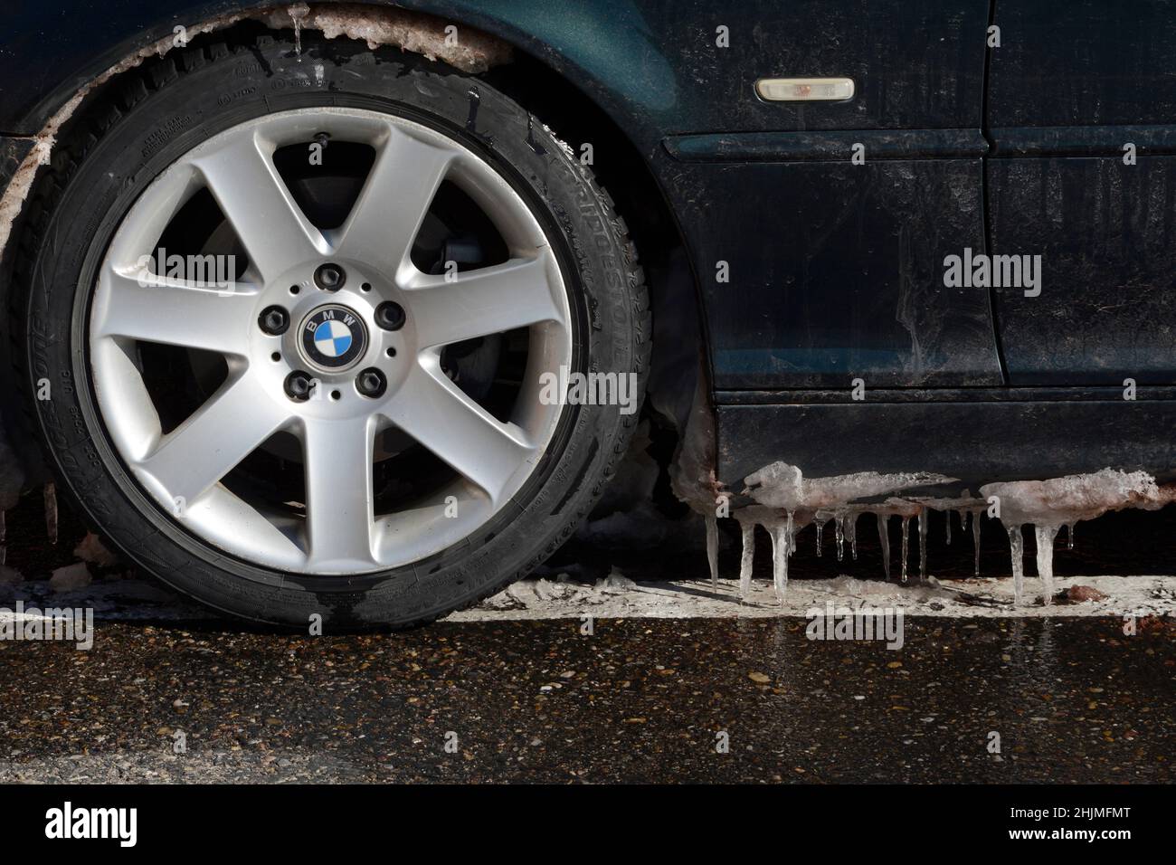 Icicles hang from the bottom of a BMW automobile parked in Santa Fe, New Mexico. Stock Photo