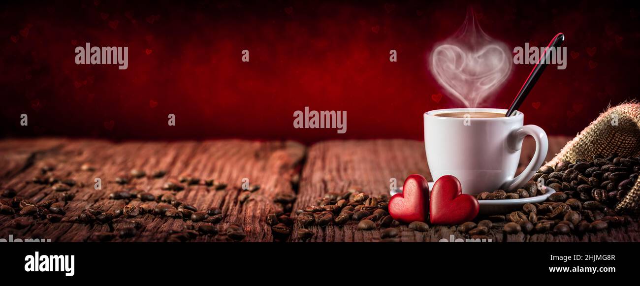 Espresso Cup And Saucer With Heart Shaped Steam And Red Hearts On Wooden Table - Valentine's Day Stock Photo