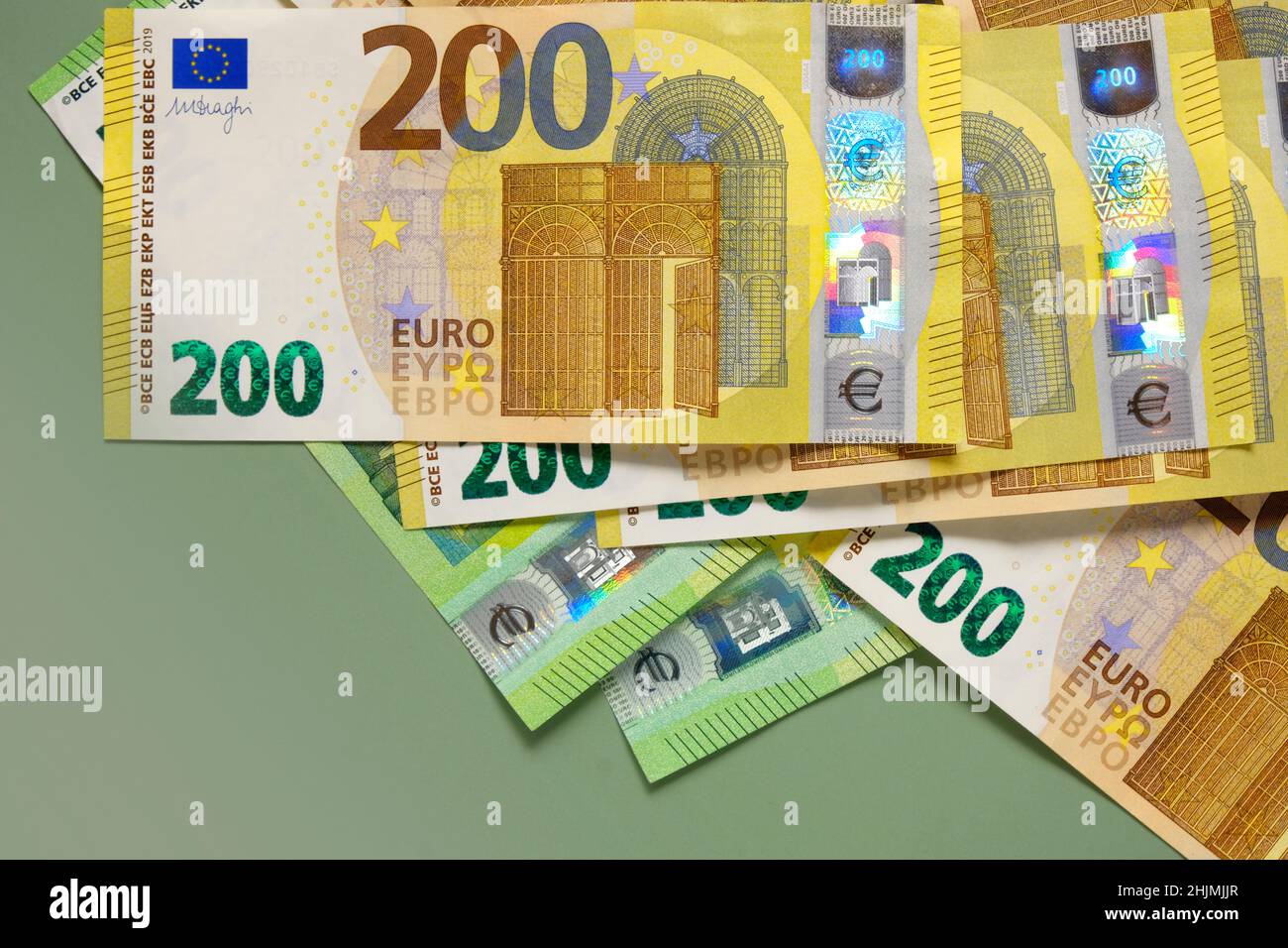 Money background.Euro banknotes. One and two hundred euro banknotes on a green background.Money and finance.Finance and savings. Stock Photo