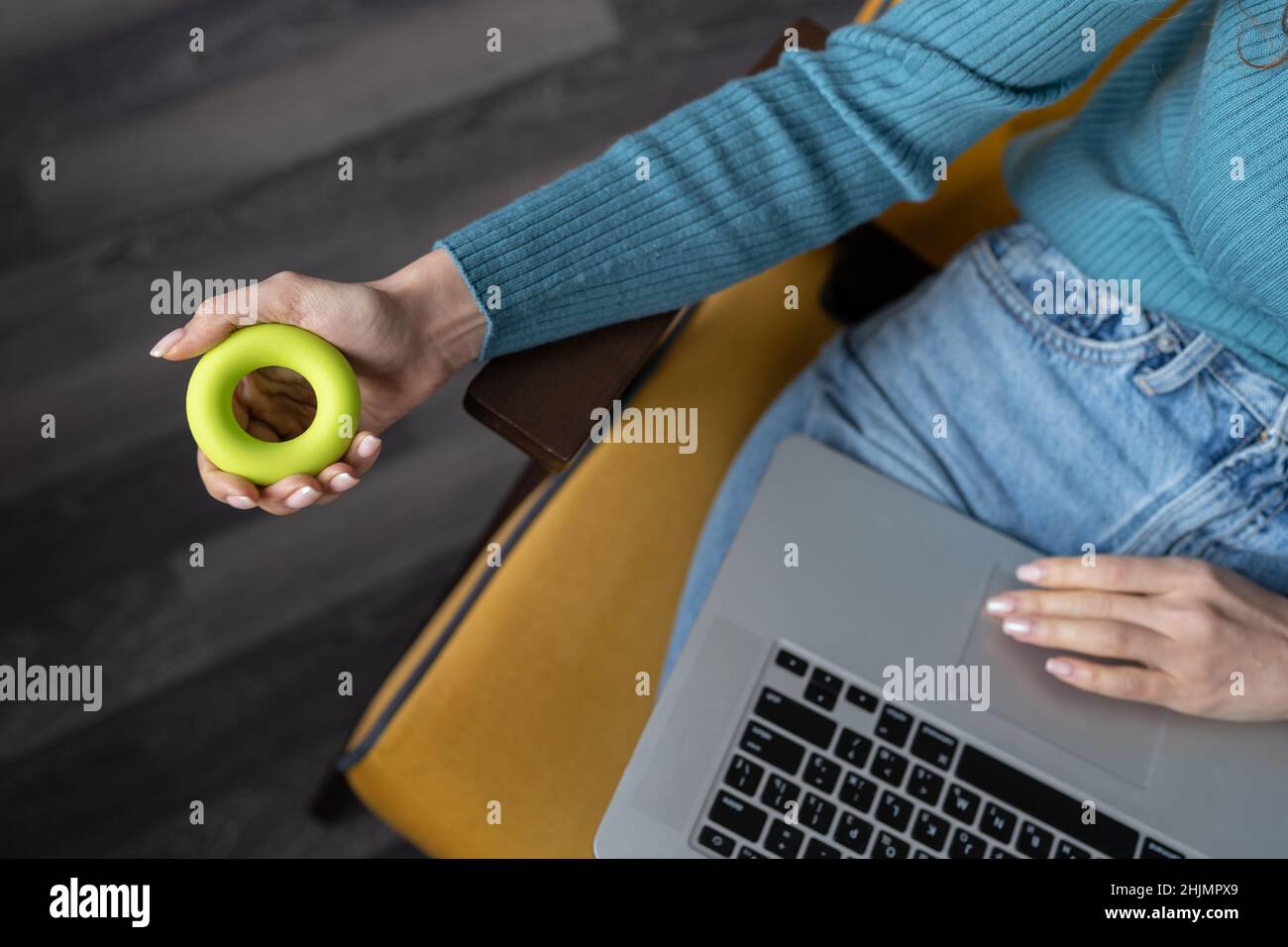 Woman doing gymnastics with expander for carpal tunnel syndrome, wrist