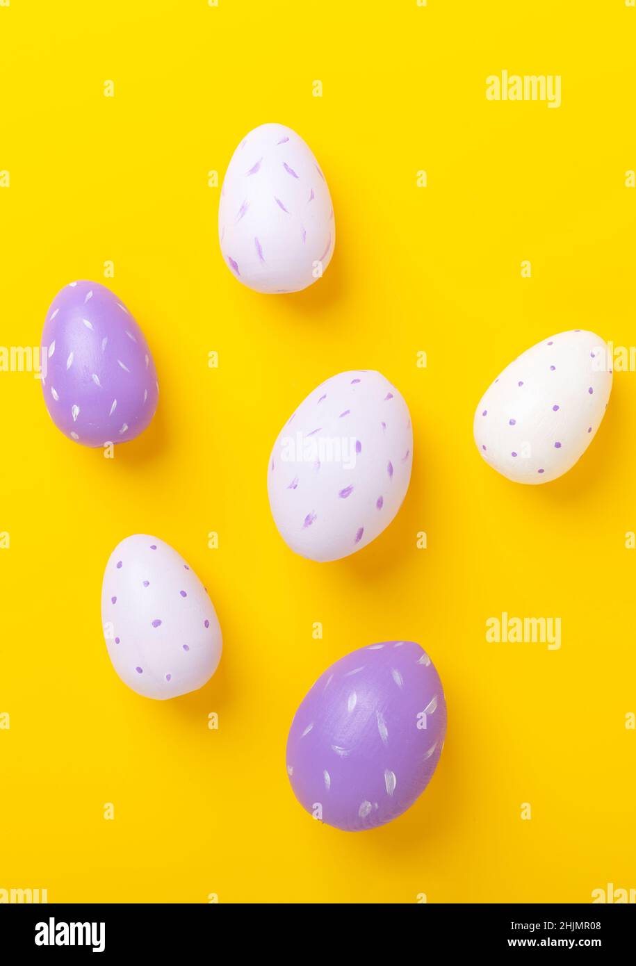 Multicolored easter eggs on yellow background. Easter concept. Top view. Copy space Stock Photo
