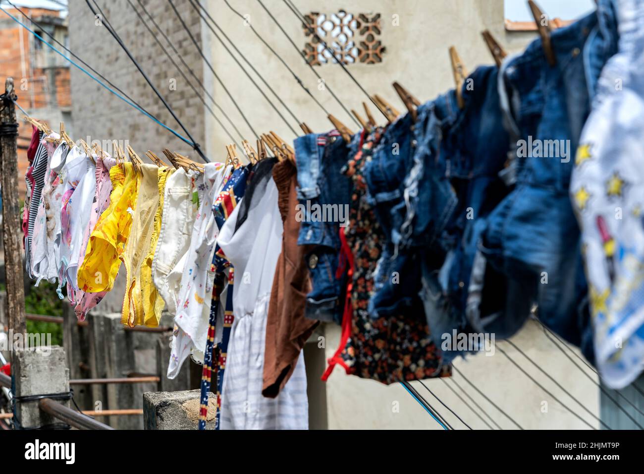 Different clothes hanging on a clothesline. Stock Photo