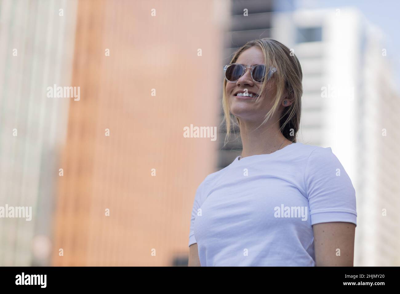 Portrait of a beautiful blonde woman on a big city street on an urban ...