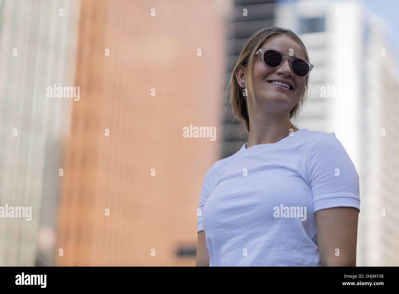 Portrait of a beautiful blonde woman on a big city street on an urban ...