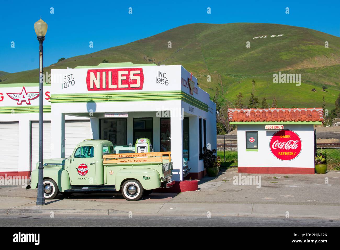 Niles Flying A restored historic gas station and repair shop facade and exterior. The Niles sign on the green hill. - Fremont, California, USA - 2022 Stock Photo