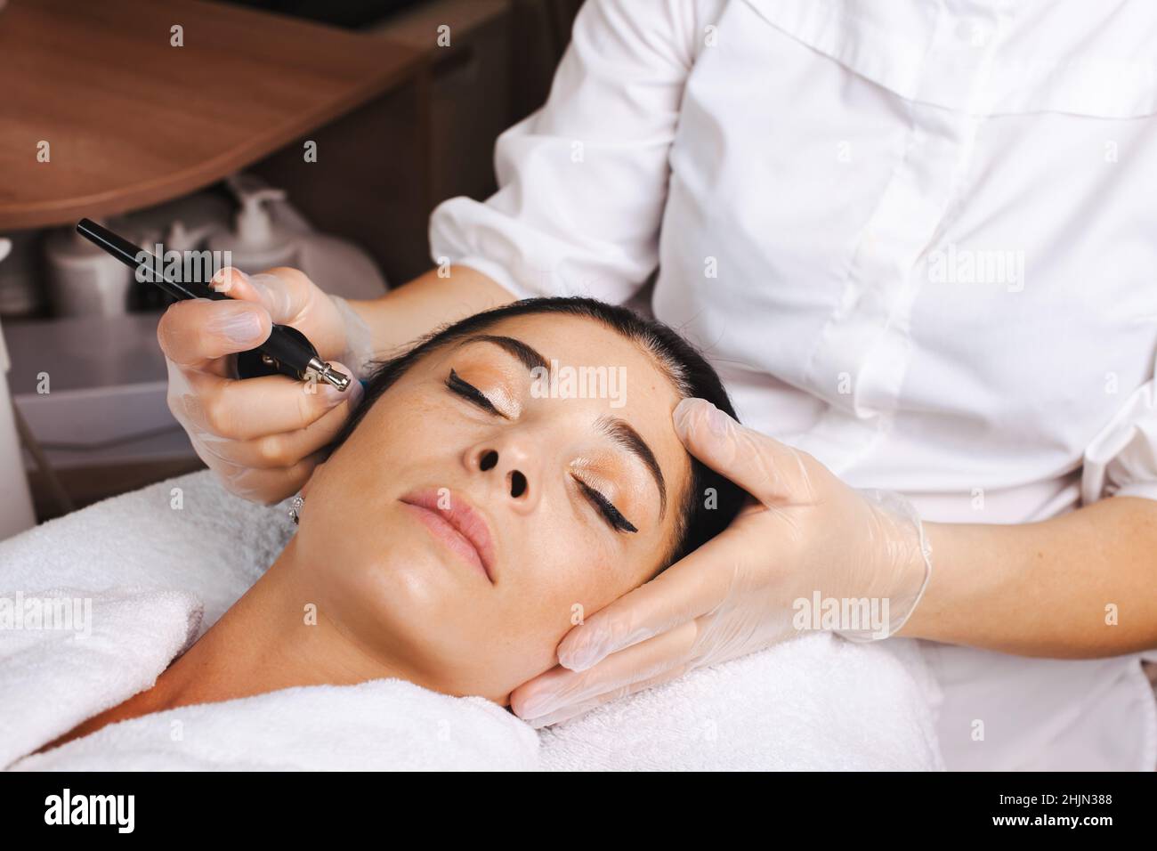 Closeupportrait of woman face receiving facial microcurrent treatment