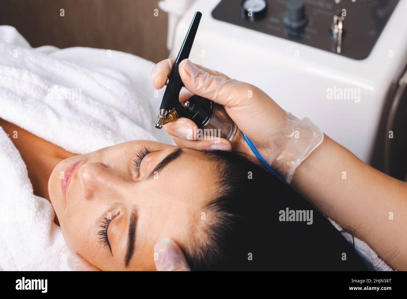 Woman getting facial gas-liquid oxygen peeling using professional equipment at spa salon. Facial skin treatment. Facial skincare. Rejuvenation Stock Photo