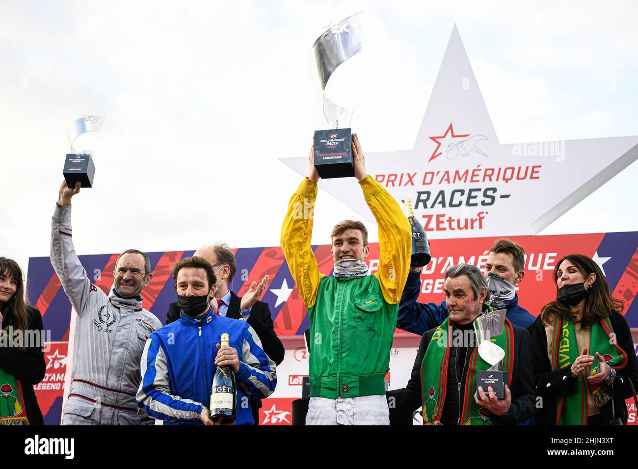 From left, Jockey/driver Jean-Michel Bazire, Yoann Lebourgeois (2nd),  Nicolas Bazire (1st) winning with "Davidson du Pont" and Theo Duvaldestin  (3rd) during the podium ceremony of the Grand Prix d'Amerique Legend Horse  Race