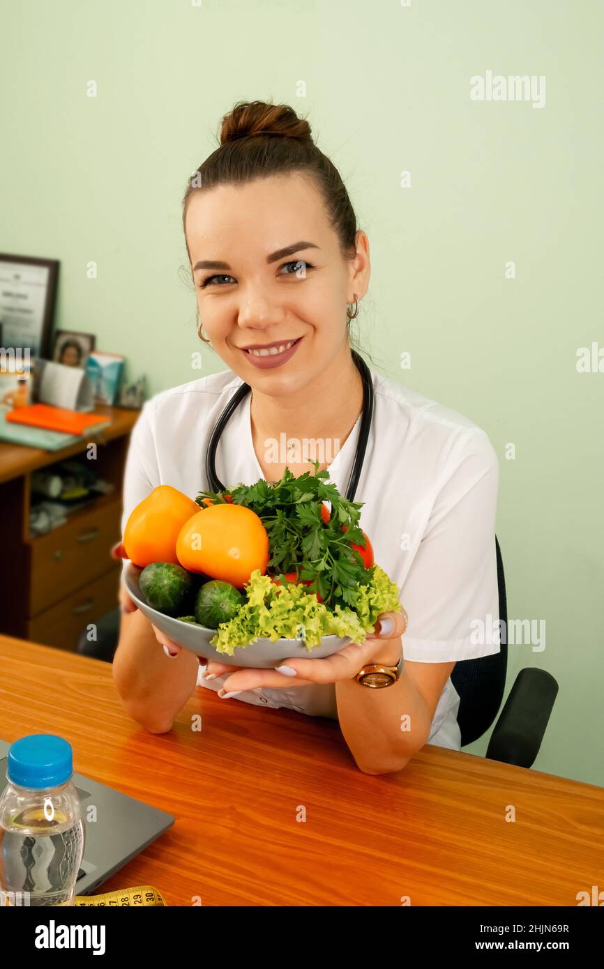Nutritionist giving consultation to patient with healthy vegetable