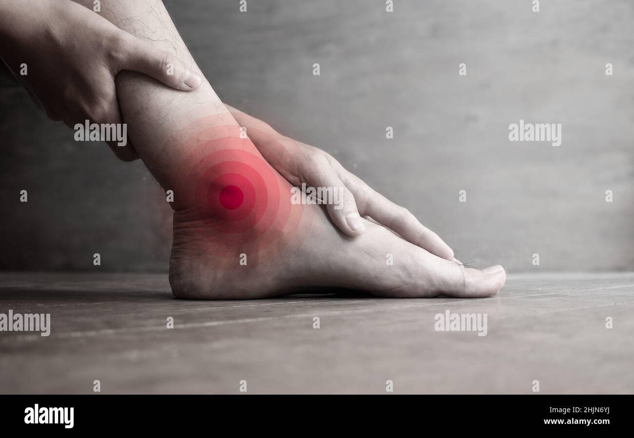 Inflammation of Asian young man’s ankle joint and foot. Concept of