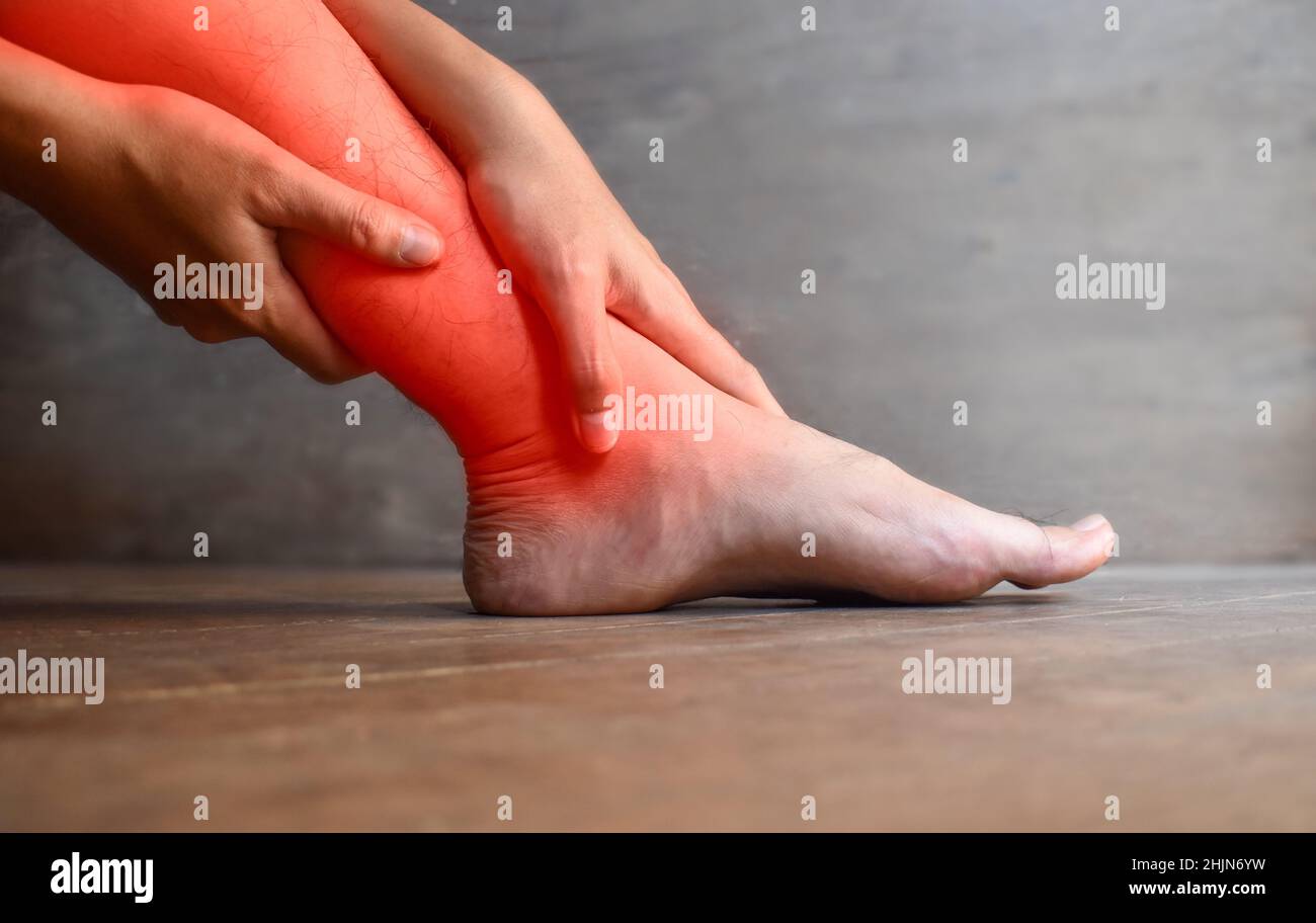 Inflammation of Asian young man leg. Concept of leg pain, tetany or calf muscle tenderness. Stock Photo