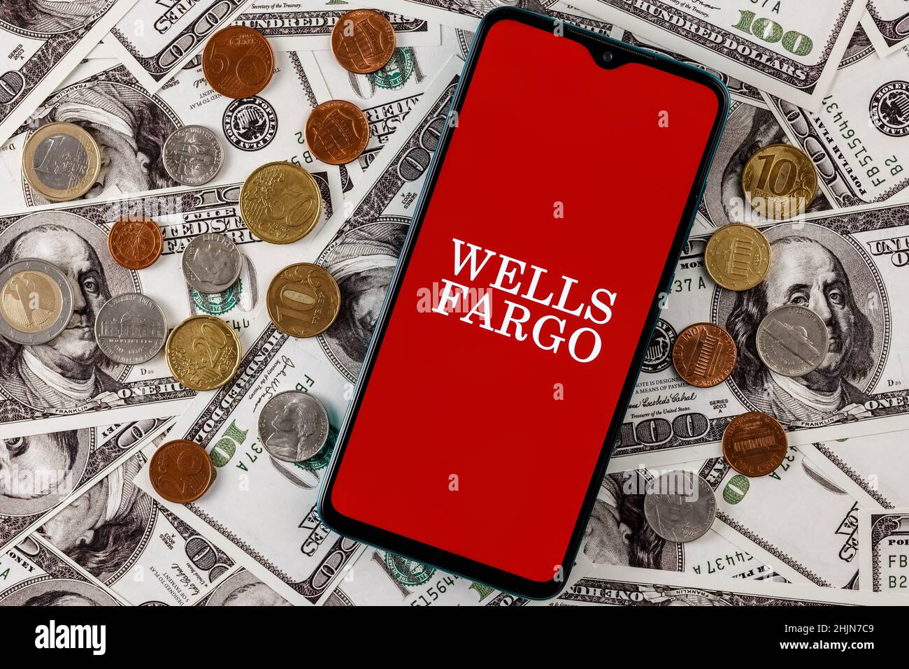 Smartphone with Wells Fargo bank logo surrounded by variety of metal