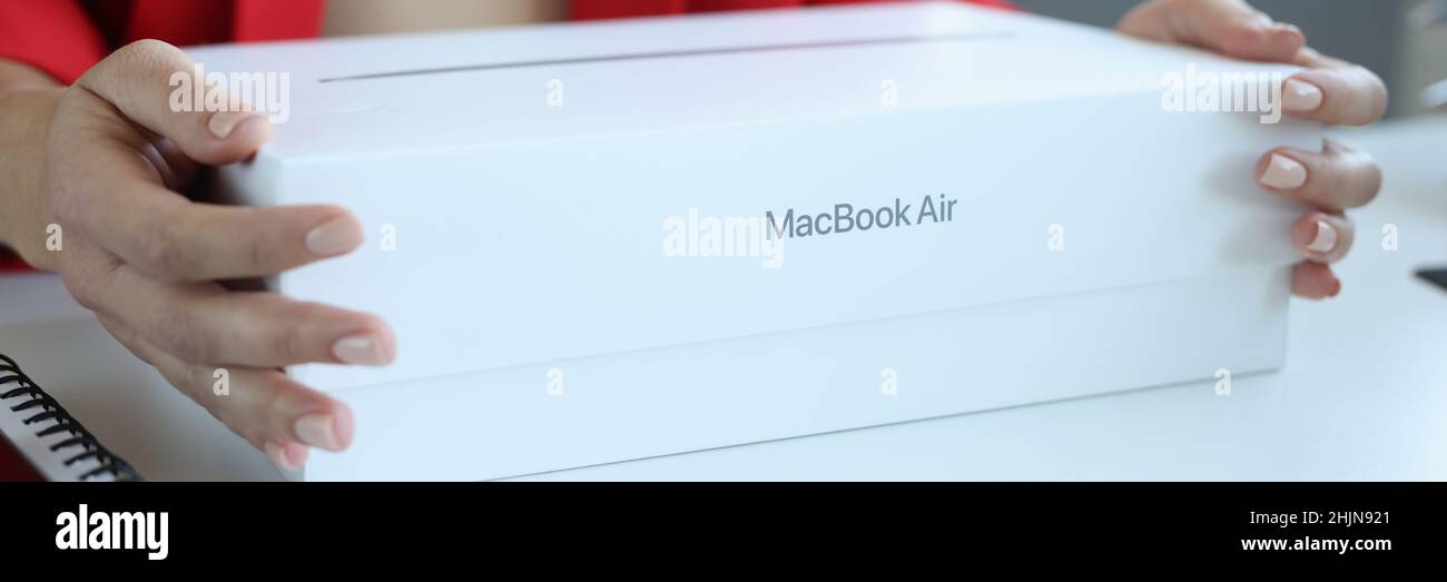 In female hands box from MacBook Air laptop Stock Photo