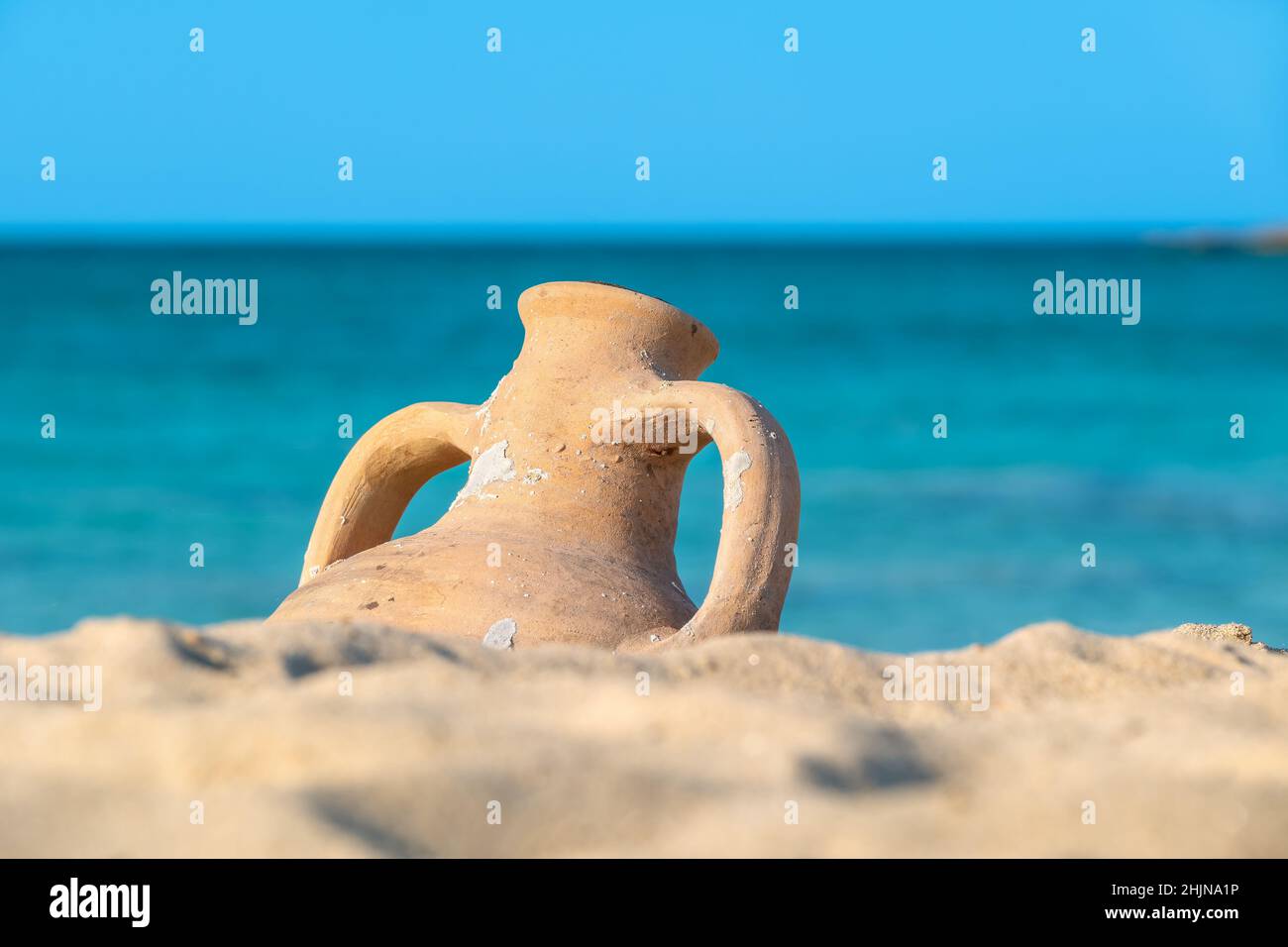Old greek Amphora on a seashore. Crete, Greece Stock Photo