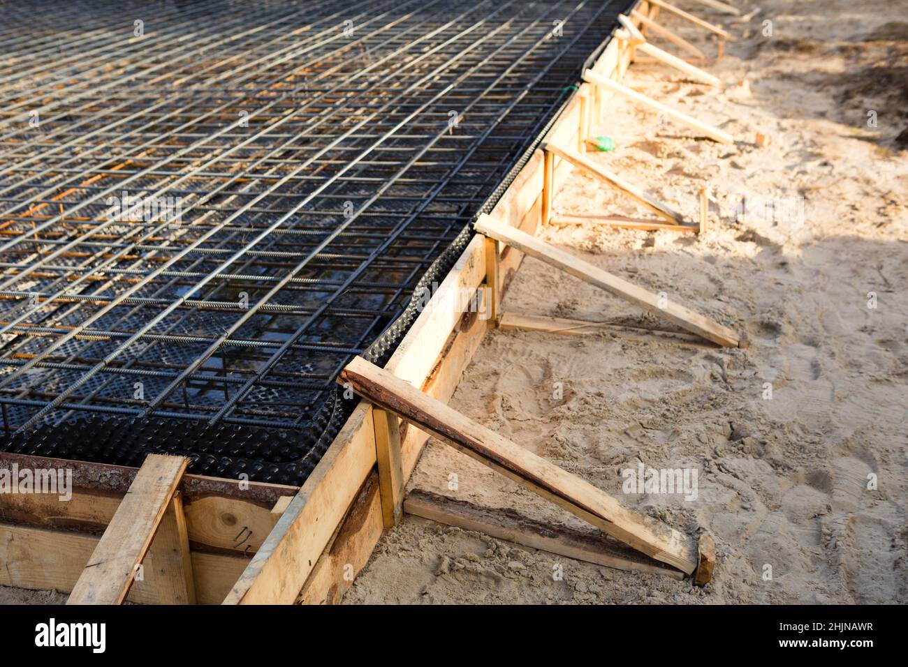 Iron fittings on a wooden formwork with laid pipes are the basis for