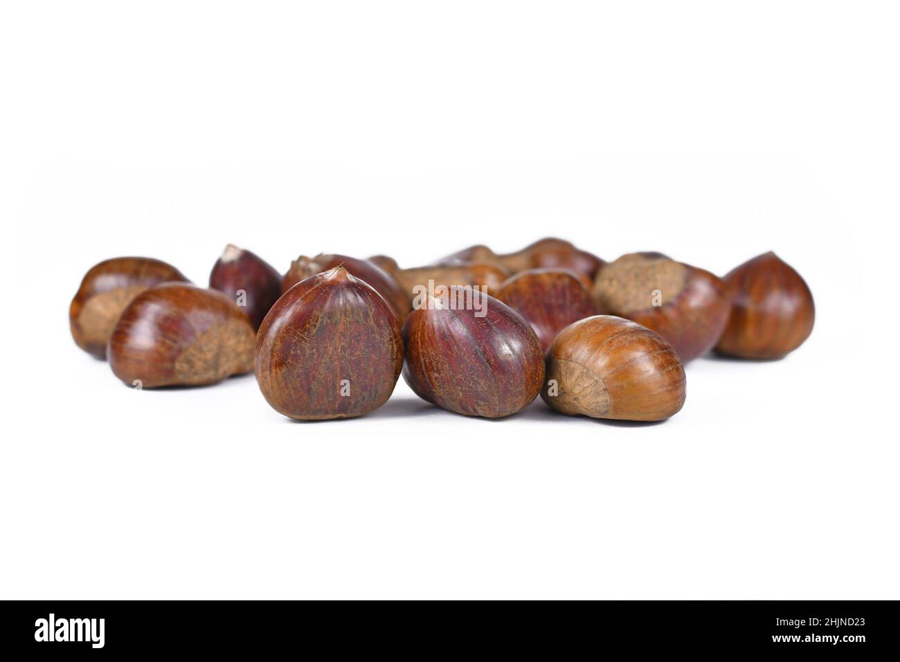 Whole raw sweet chestnuts on white background Stock Photo