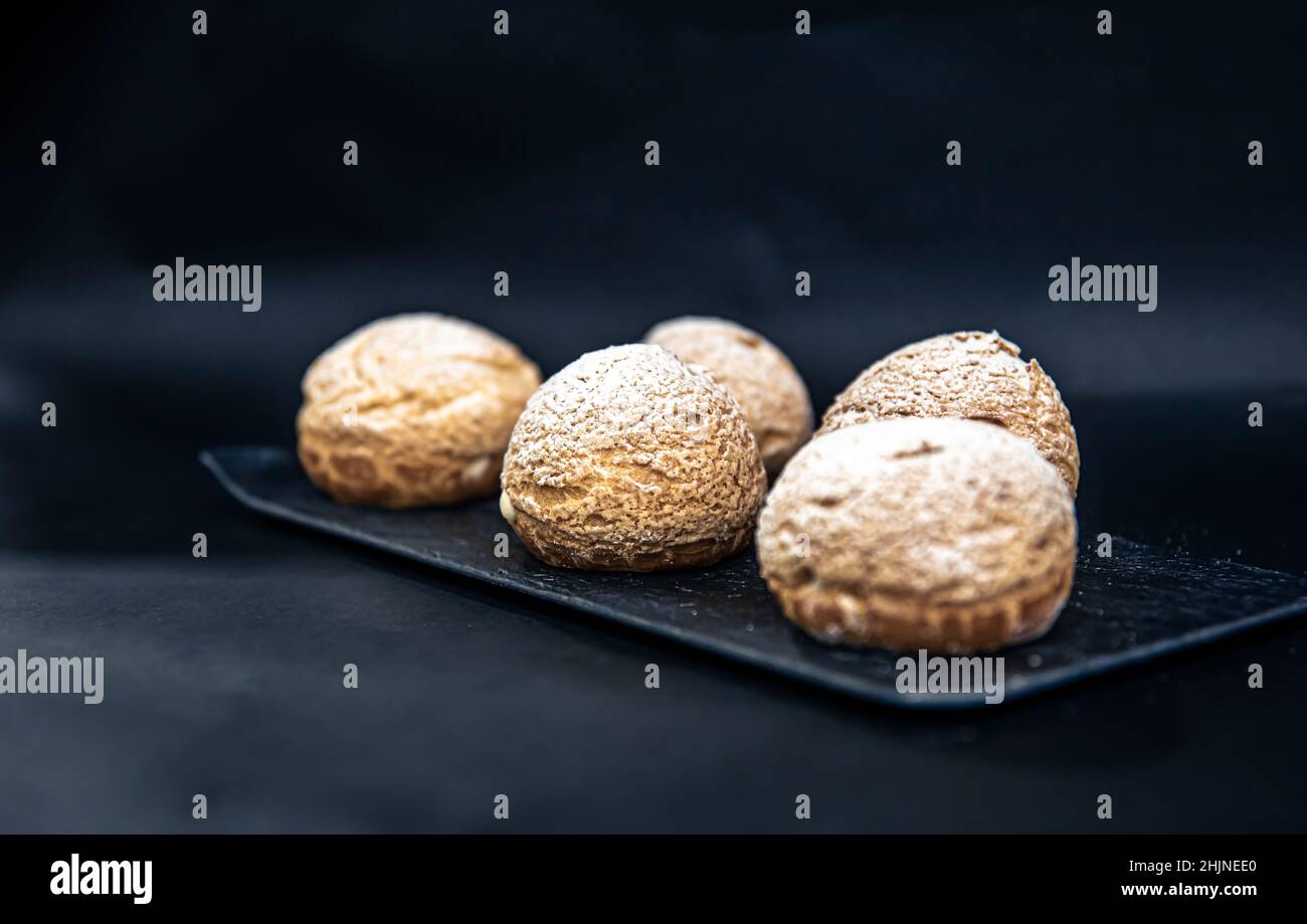 Appetizing Shu cakes on a black background. Stock Photo