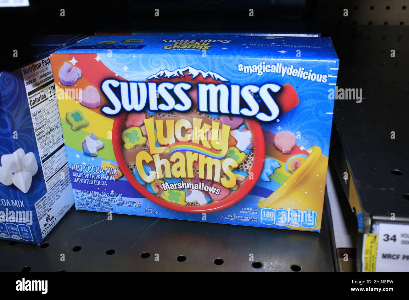 A closeup of SWISS MISS LUCKY CHARMS Hot Chocolate Mix in colorful boxes on a metal shelf at a Dillons grocery store Stock Photo