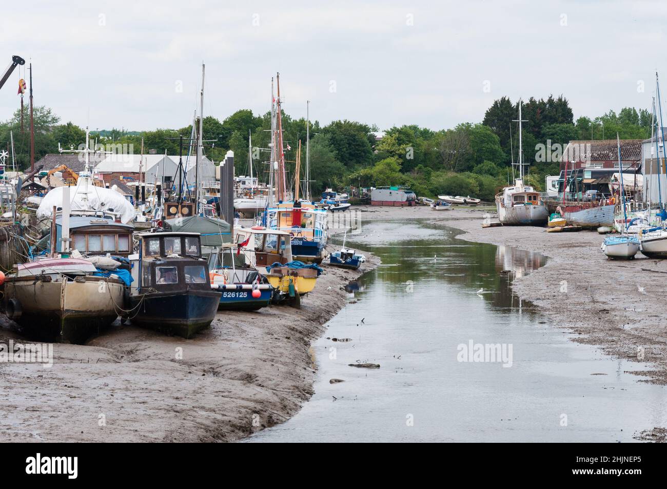 Low tide with grounded boats and sailing yachts moored in the River